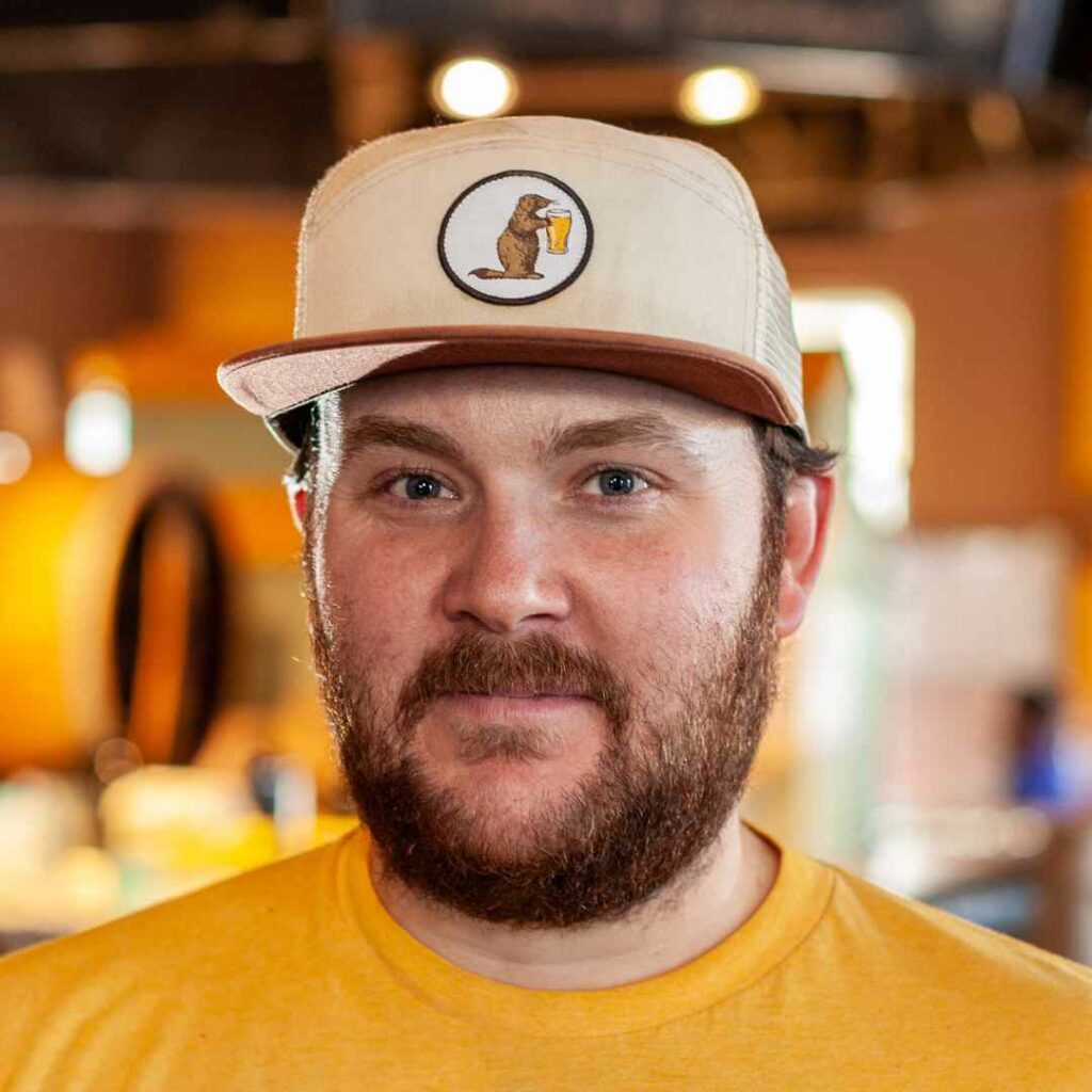 Prairie Dog Brewing head brewer Curtis Grieb, headshot wearing a branded Prairie Dog Brewing hat.