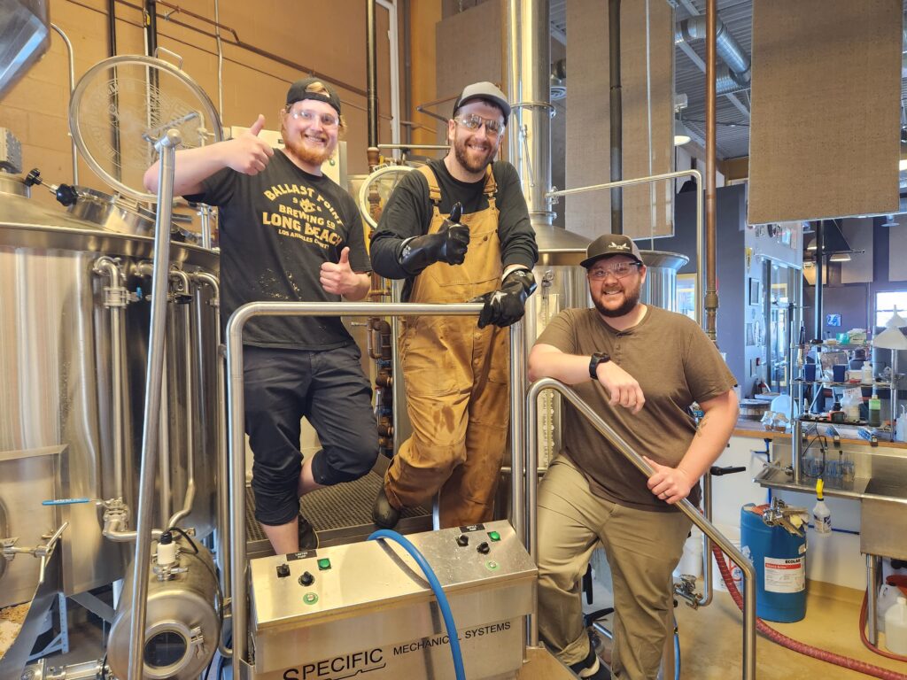 Fallentimber Meadery brewer Elliott Johnson joins Nigel and Curtis on the Prairie Dog brew deck during a summer 2024 collaboration brew.