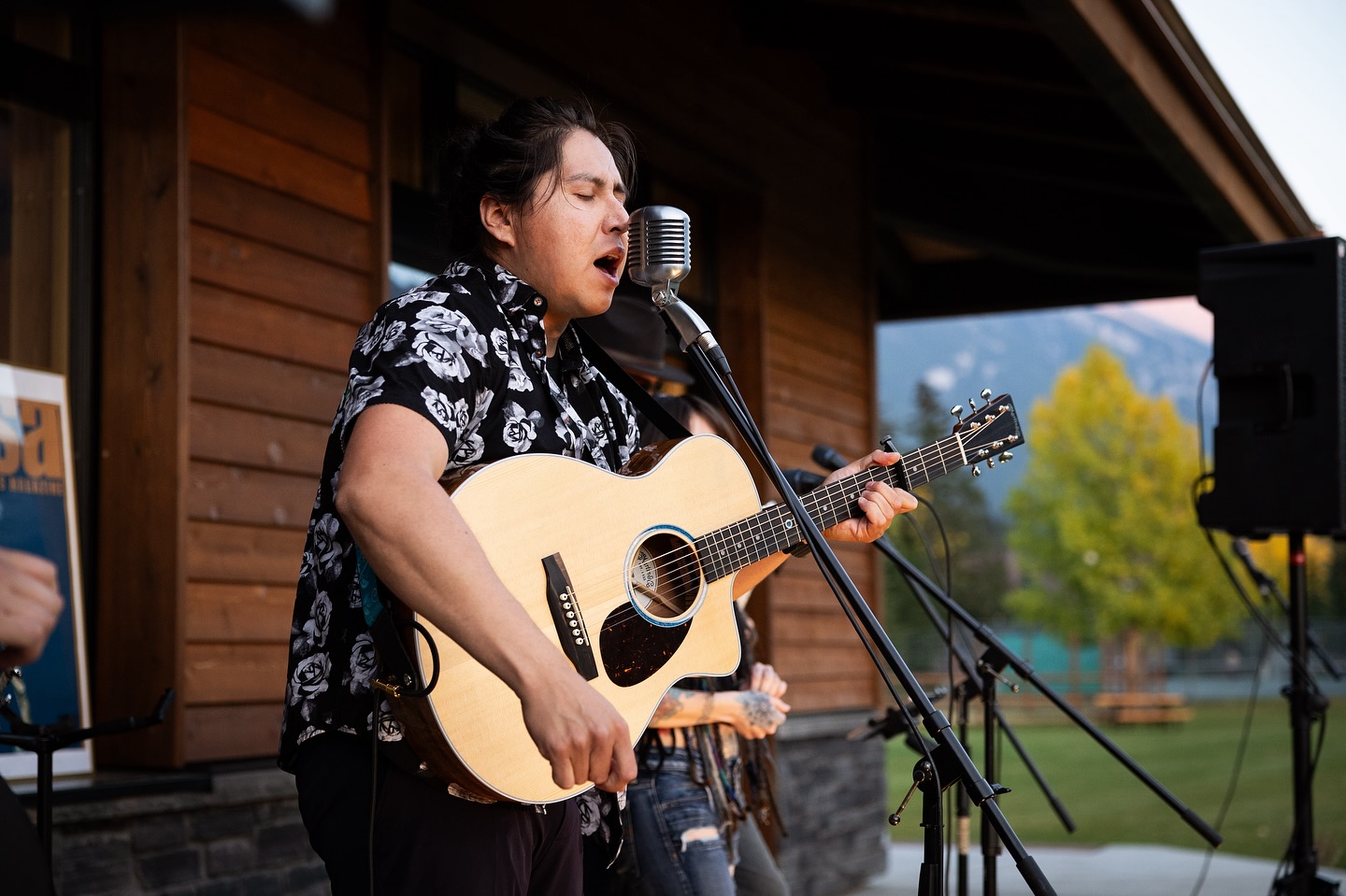 Calgary-area musician Johnny Munro plays guitar and sings on stage in Banff.