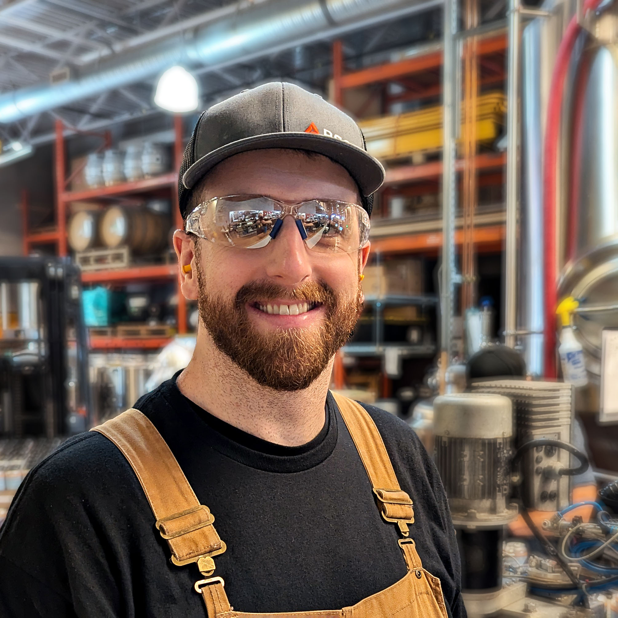 Prairie Dog Brewing head brewer Curtis Grieb, headshot wearing a branded Prairie Dog Brewing hat.