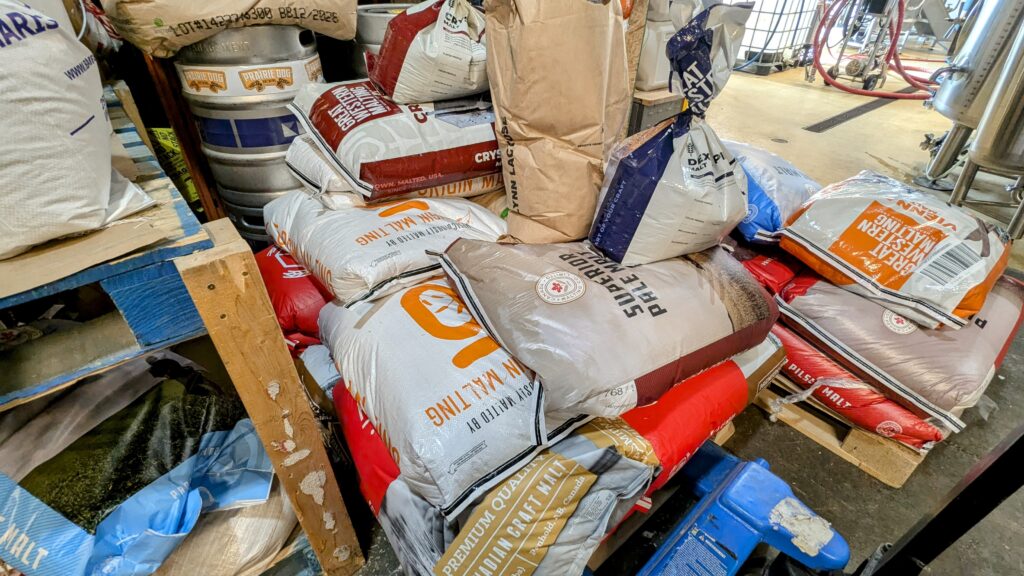 Stacks of bags of locally produced malts sit on pallets in Prairie Dog Brewing's Calgary brewery.