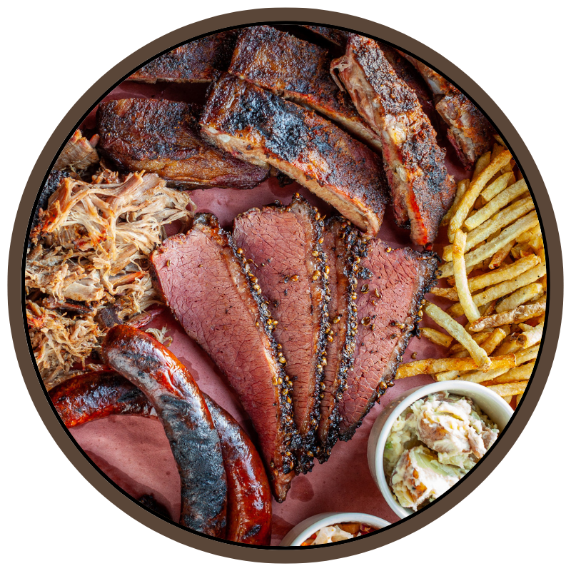 A closeup selection of cuts of BBQ meats and sides on a platter, in a circular button.