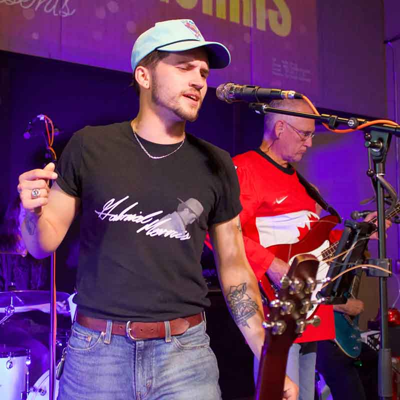Gabe Morris performing on stage at Prairie Dog Brewing for Canada Day 2025.